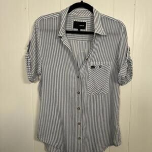 Hurley woman’s striped button-down shirt with roll-tab sleeves.